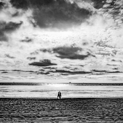 photo en noir et blanc promeneur sur la plage